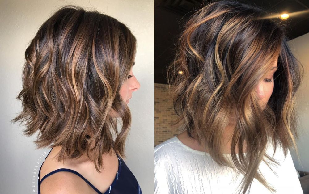 Black hair with soft brown balayage highlights, medium-length wavy hairstyle, natural lighting