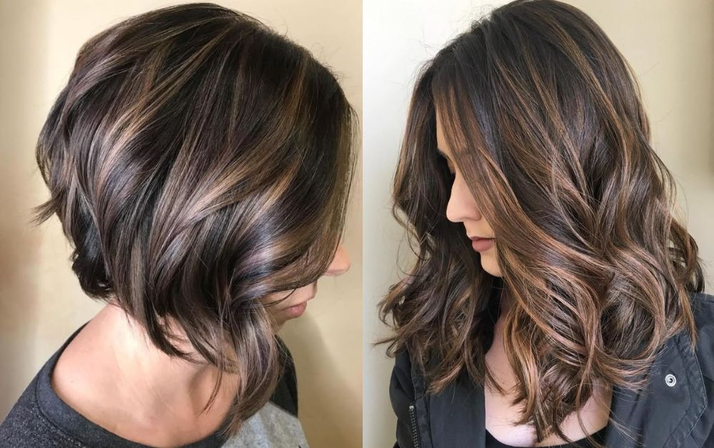 Trendy black hair with thick, bold brown highlight streaks, modern haircut