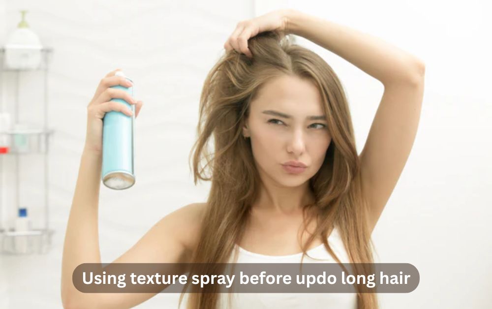 Woman prepping hair with texture spray before creating an easy updo style.